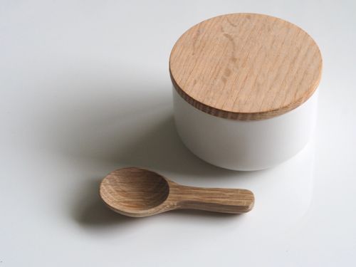 Free A white round container with a wooden lid and wooden spoon on a white surface. Simple and clean design. Stock Photo