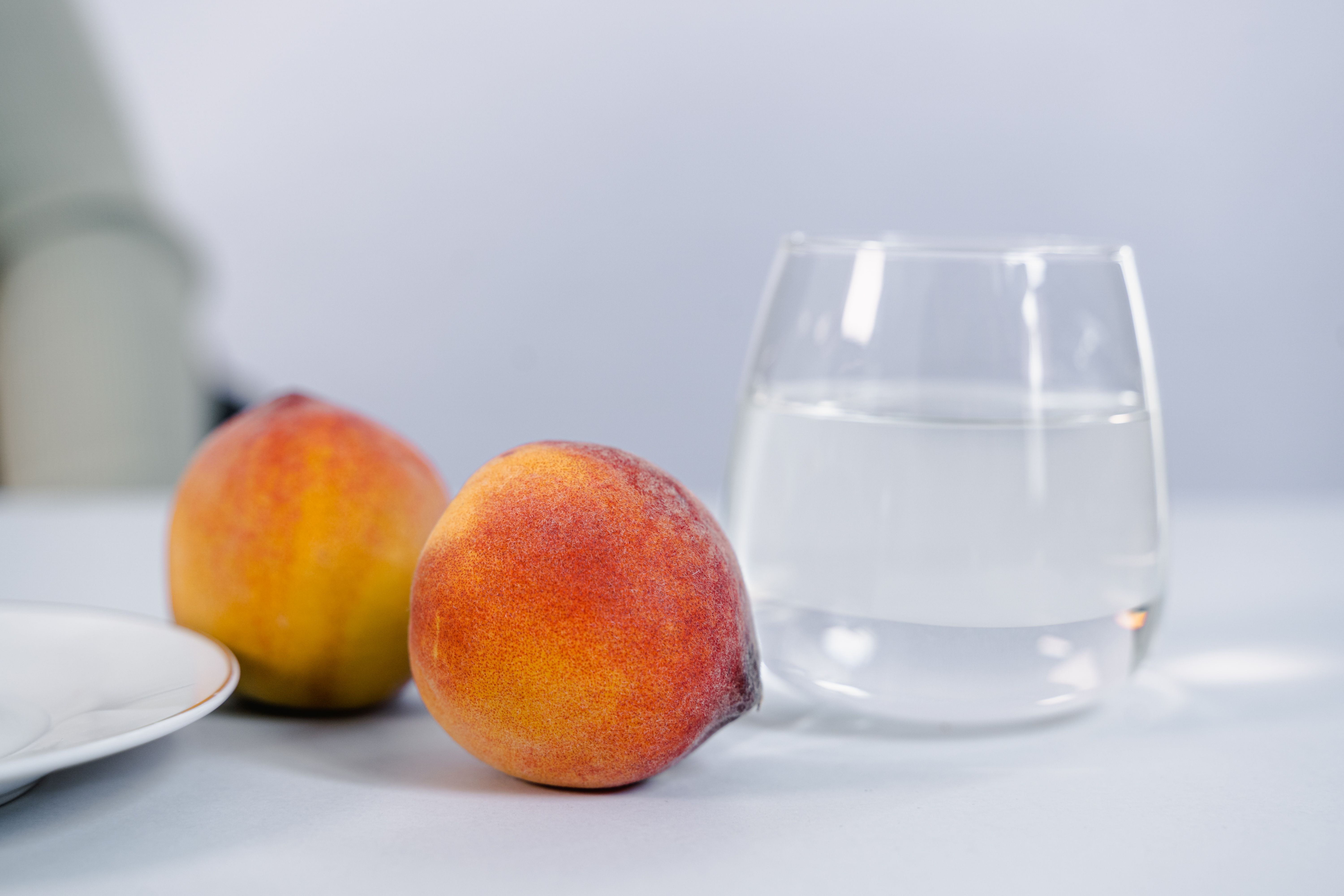 A ripe water peach cut open, showing juicy flesh