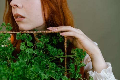 A Woman Holding a Green Plant