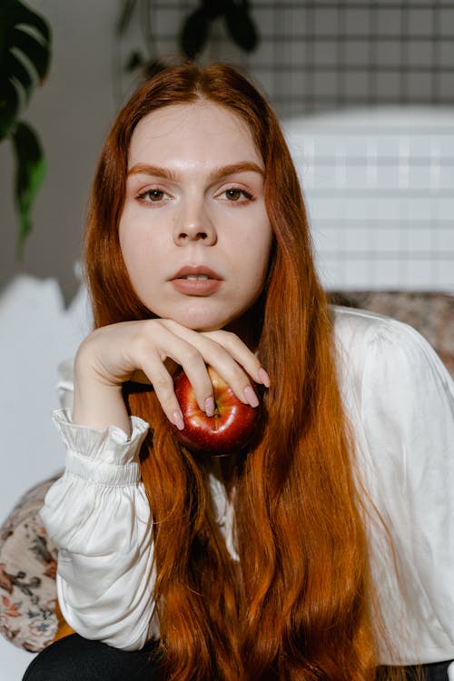 A Woman Posing Holding Apple 