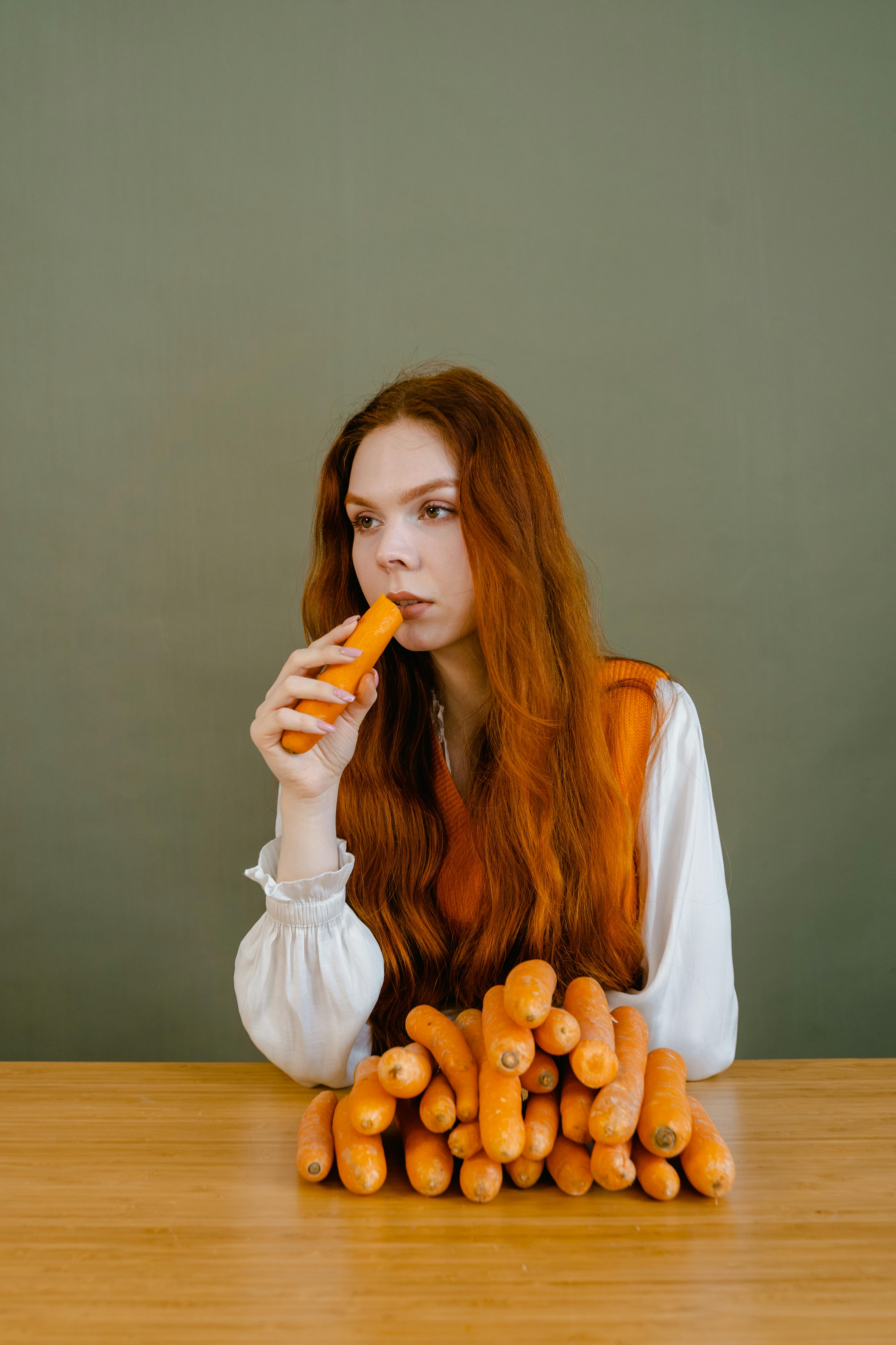 A Woman Eating Carrot · Free Stock Photo