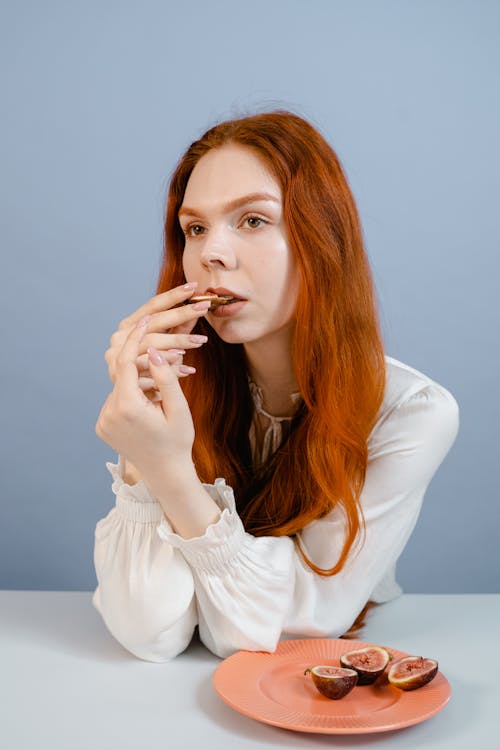 A Woman Eating Fig Fruit