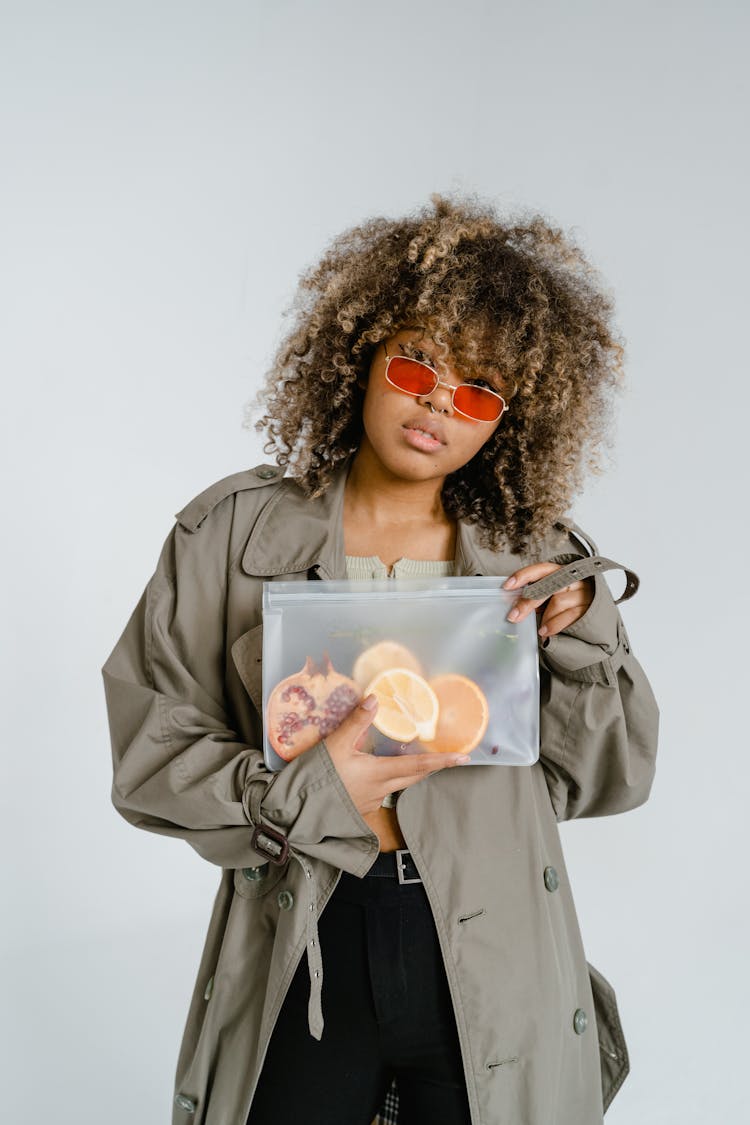 A Woman Holding Fruits In A Zip Lock Bag