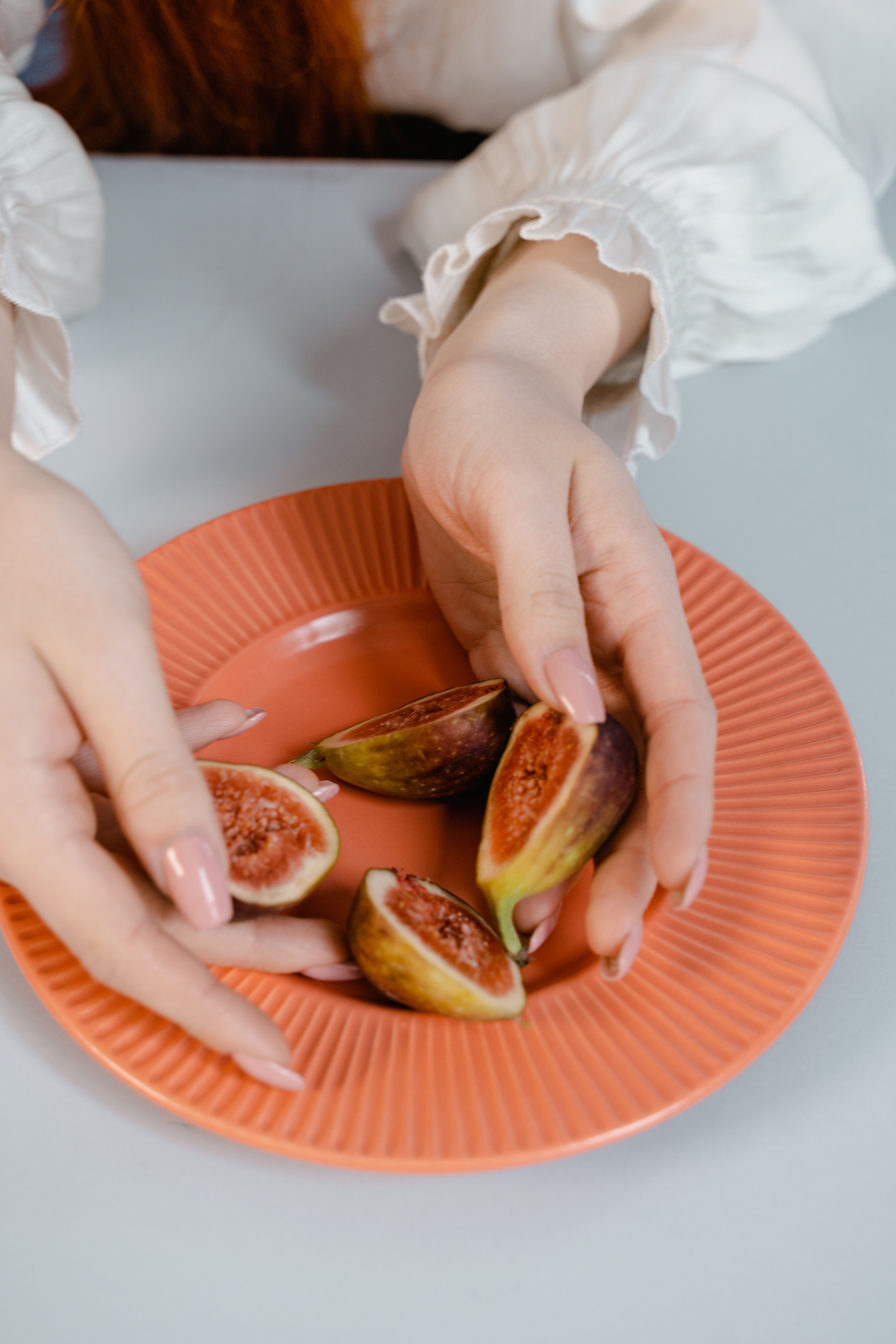 Person holding ripe fig fruits — the reward of a well-pruned and healthy fig tree