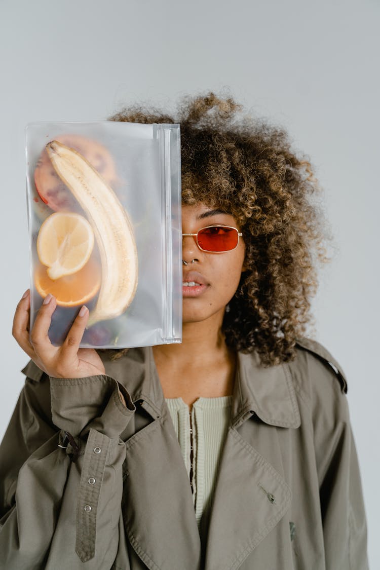 Woman Holding A Clear Bag With Fruits