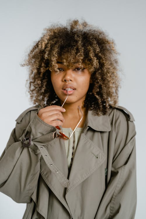  A Curly Haired Woman Wearing a Gray Coat
