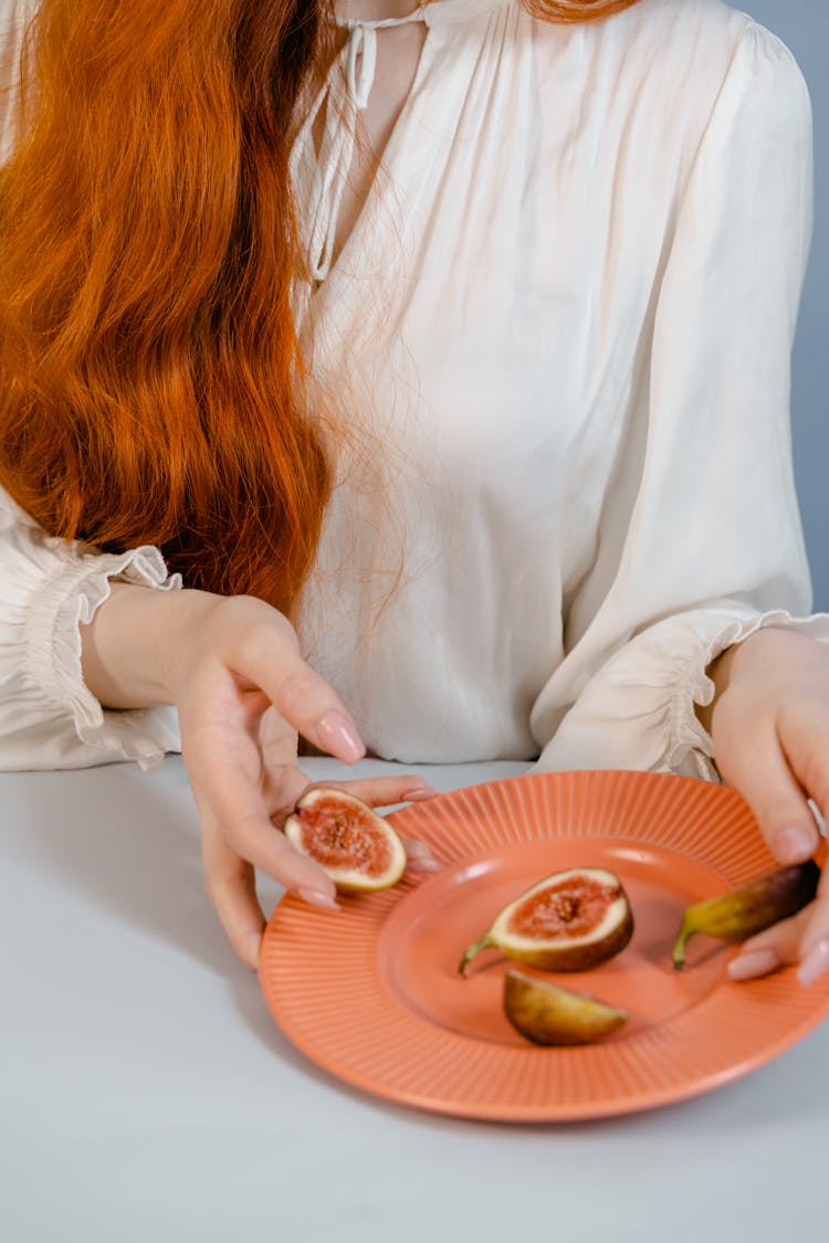 A Woman Holding Eggplants Cut In Half