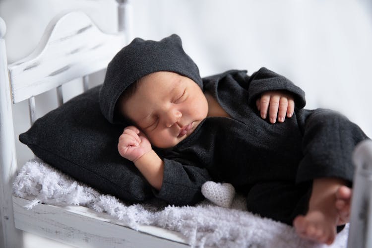 Cute Baby In Black Clothes Sleeping