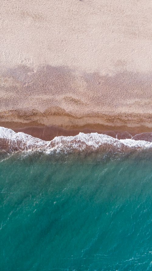 Free Stunning aerial view of Antalya's turquoise waters meeting sandy shores, capturing the beauty of Türkiye's coastline. Stock Photo