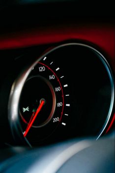 Detailed vertical shot of a classic car speedometer with a focus on its dial.