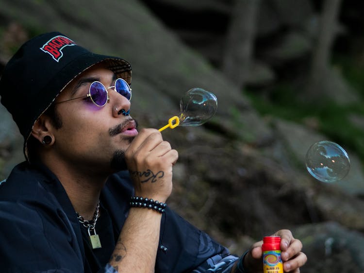 A Man Blowing Soap Bubbles 