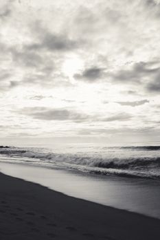 A serene black and white shot of waves crashing on the beach at Vila Nova de Gaia, Portugal.