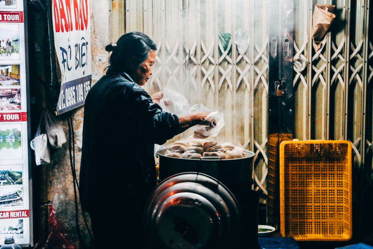 A street vendor preparing pho beside Hoan Kiem Lake in Hanoi's Old Quarter