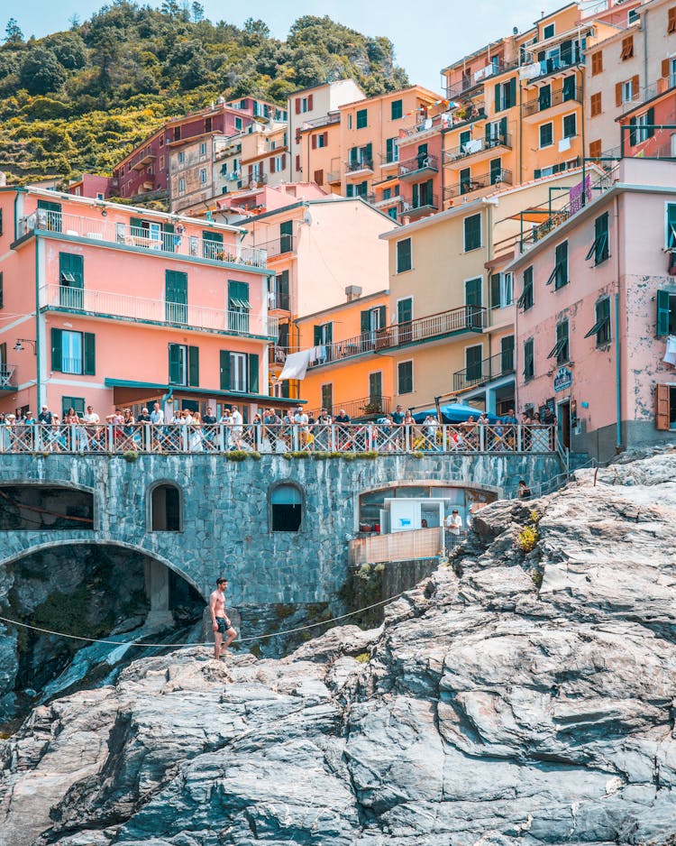 A Crowd Of People Watching Cliff Diving