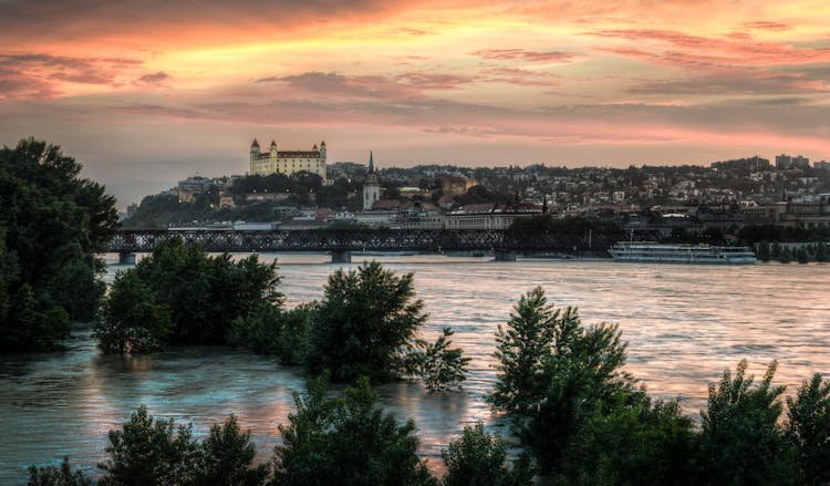 High Water Level On The Danube River With View Of Bratislava Castle On Background During Sunset  In Bratislava, Slovakia