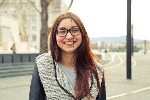 Free Woman in Gray Jacket Standing Near Brown Tree Stock Photo