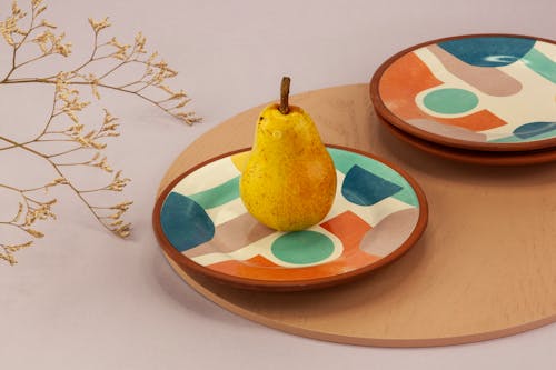 A Pear on a Colorful Plate