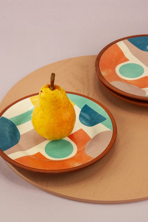A Pear on a Colorful Plate