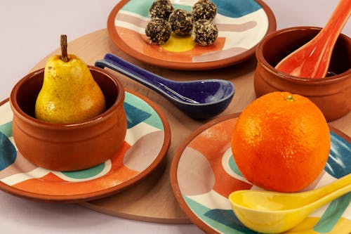 Fresh Fruits and Sweets on Ceramic Plates