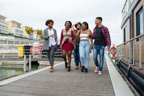 Free Group of Happy People Walking on Boardwalk Stock Photo