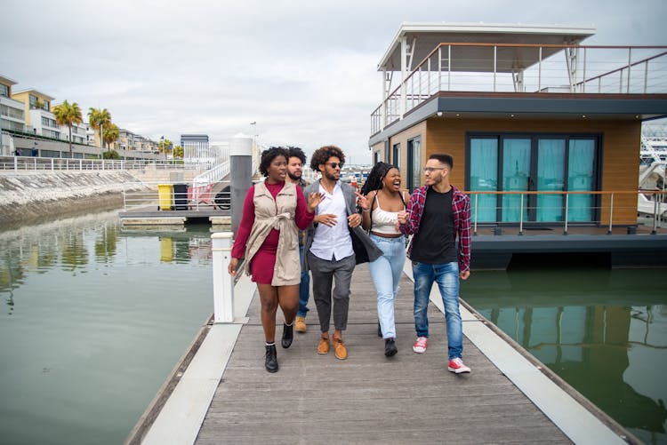 Group Of People Walking On Boardwalk