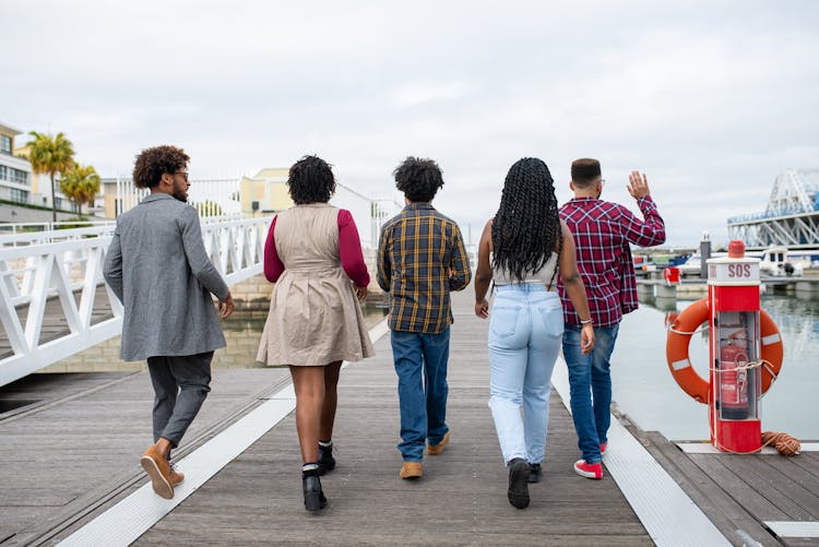 Group Of People Walking On Boardwalk