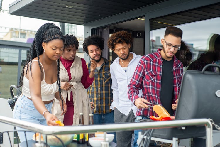 Group Of Friends In A Boat Grilling Food