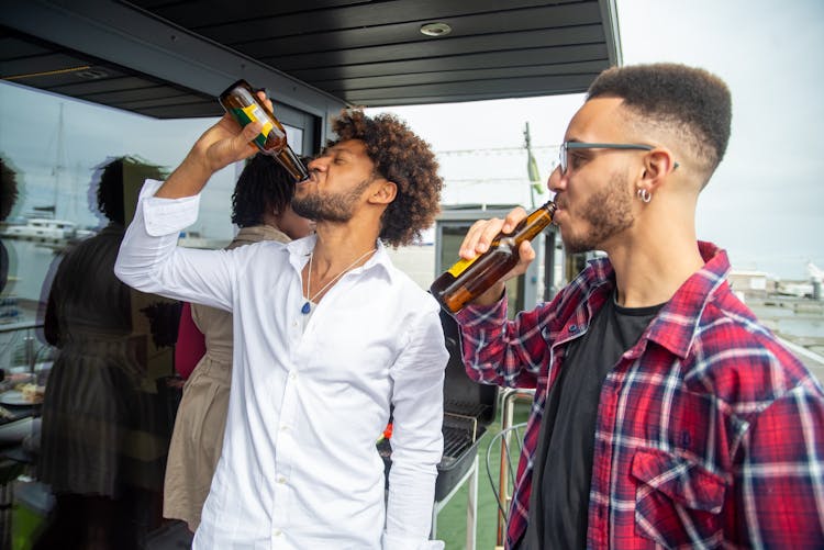 Two Men Drinking Beer Together 