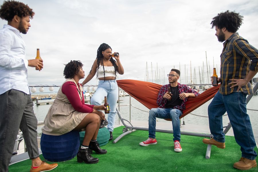 A group of friends laughing together on a dock