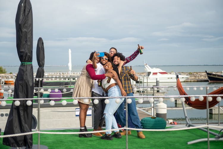 Group Of Friends Taking A Selfie In A Harbor 