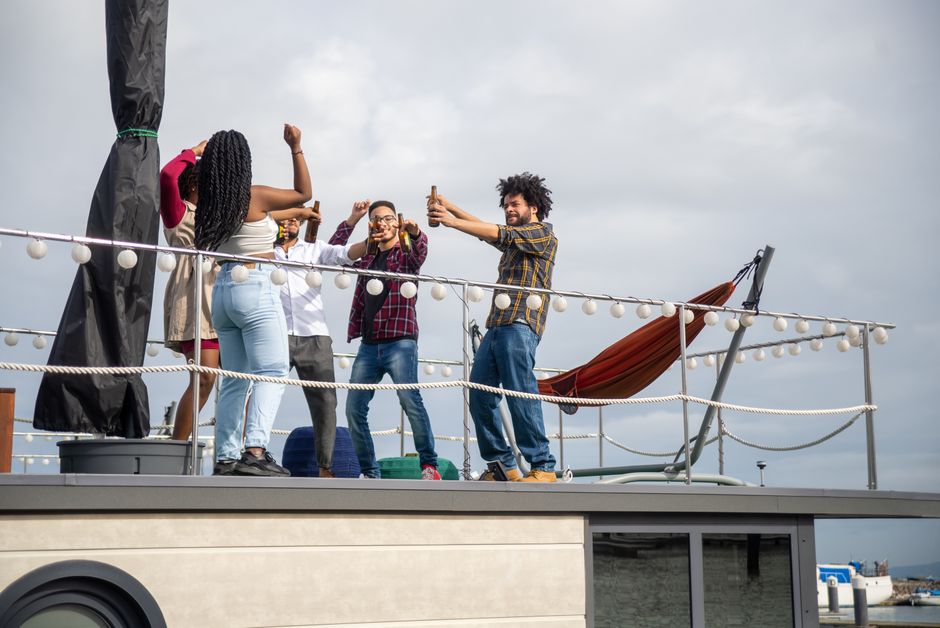 friends toasting on a yacht deck in Chicago - how to rent a yacht for a party in chicago friends toasting on a yacht deck in Chicago - how to rent a yacht for a party in chicago