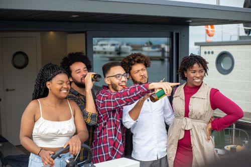 Free A group of friends having fun and enjoying drinks on a boat in Portugal. Stock Photo