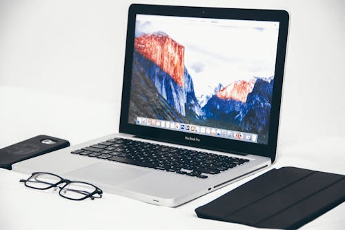 Mac Book Air рядом с очками и черным смарт футляром
