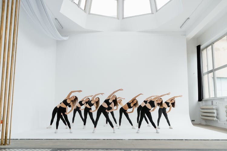 A Group Of Women Bending Sideways