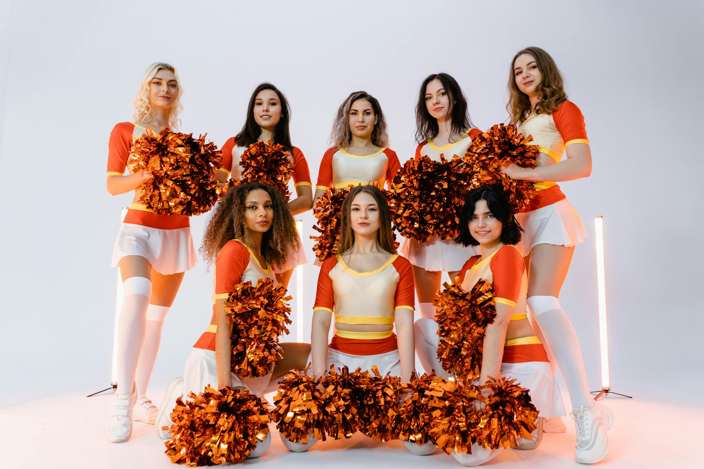 Cheerleaders in Orange Uniforms · Free Stock Photo