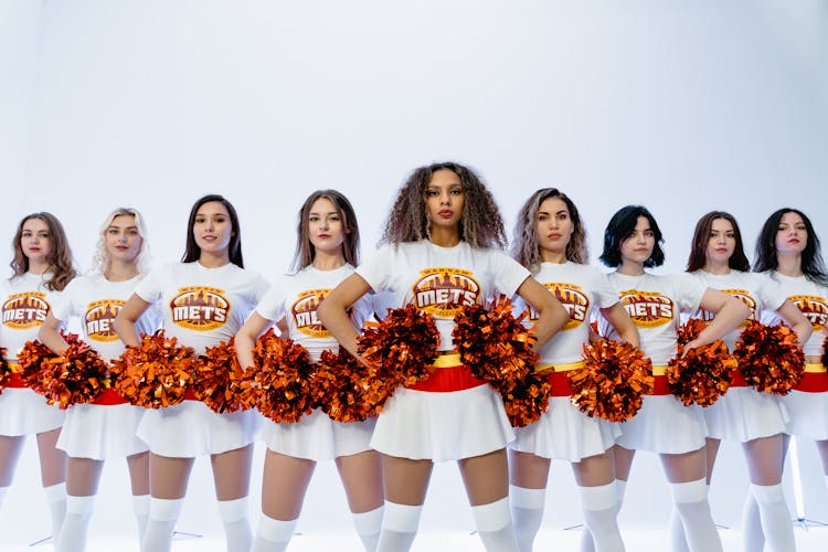 Cheerleading Squad In Uniform Holding Pompoms