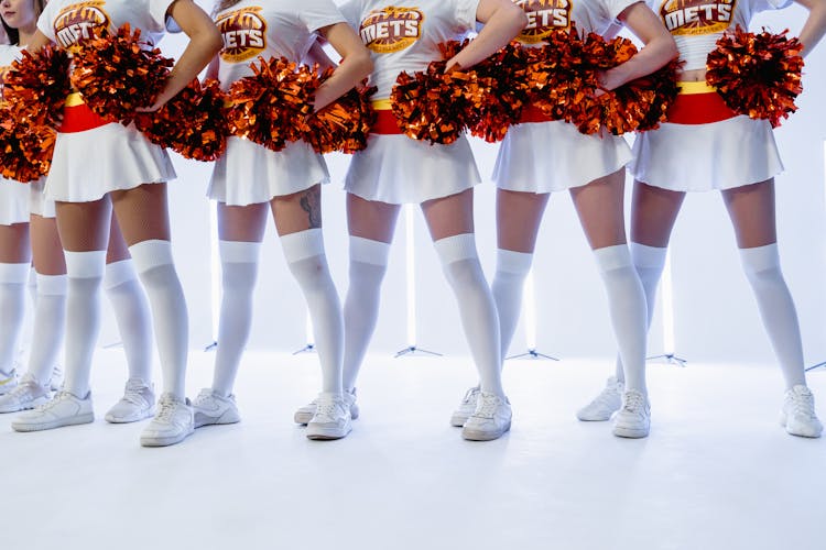 Cheerleaders Holding Pom Poms