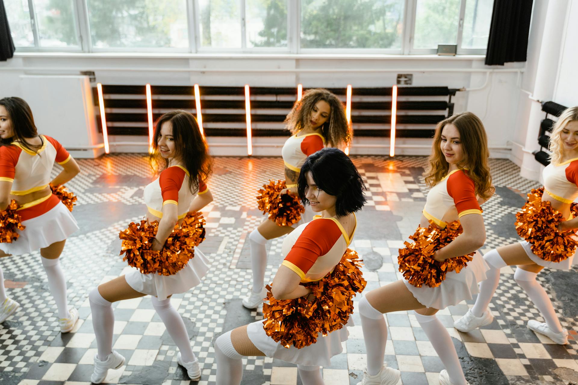 Group of Women in Cheerleading Uniforms Dancing