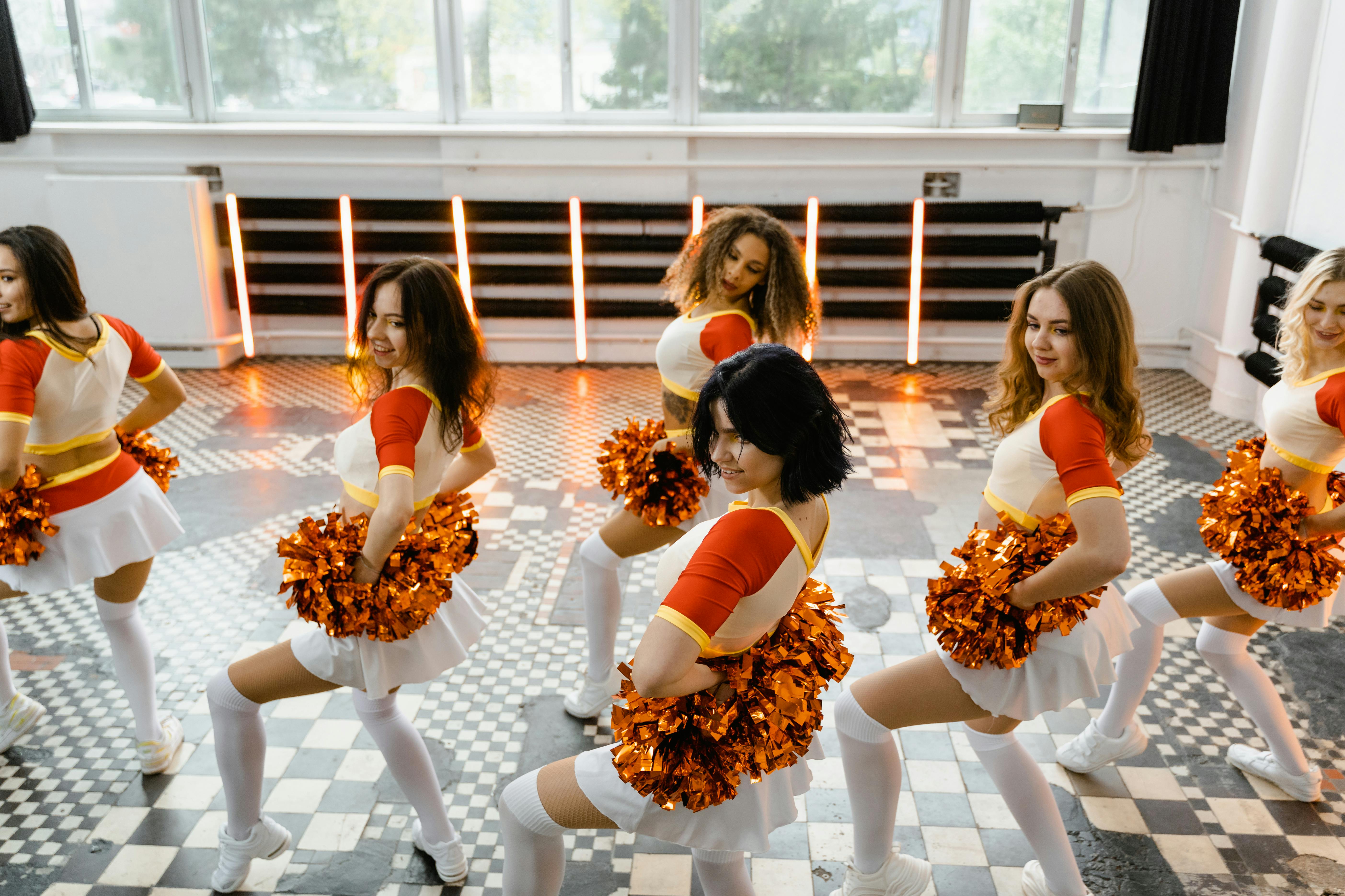 Cheerleaders Holding their Pompoms · Free Stock Photo