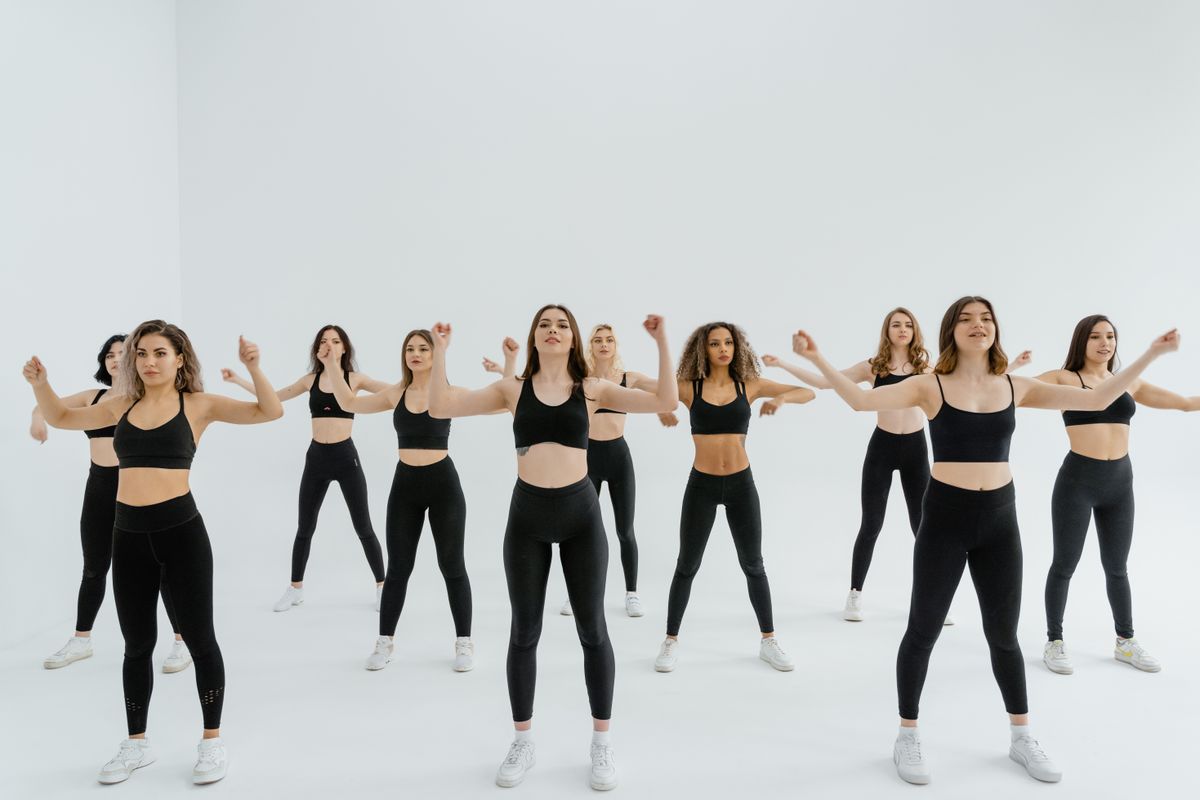 Group of women following synchronised dance fitness choreography