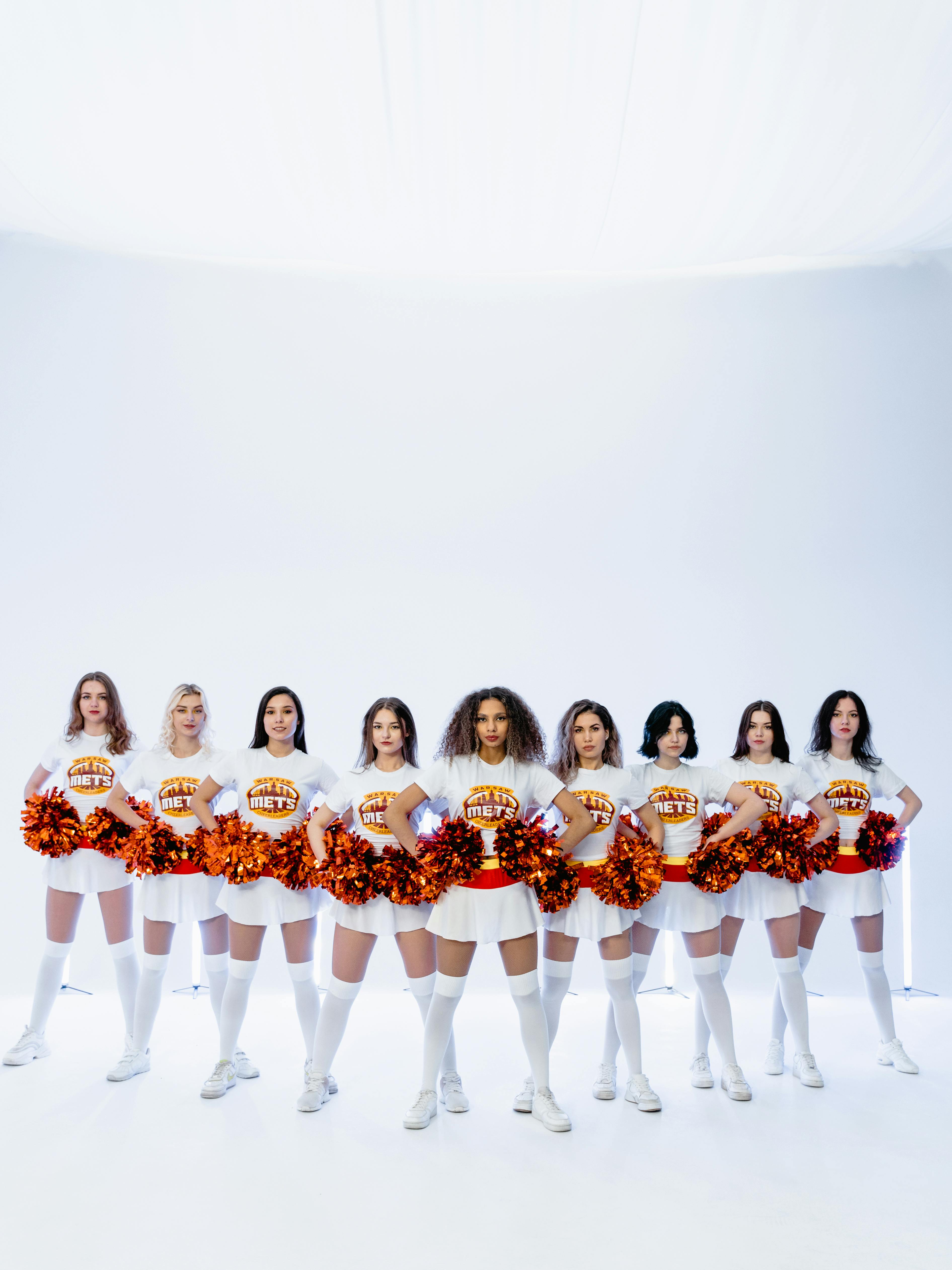 Cheerleaders Holding their Pompoms · Free Stock Photo