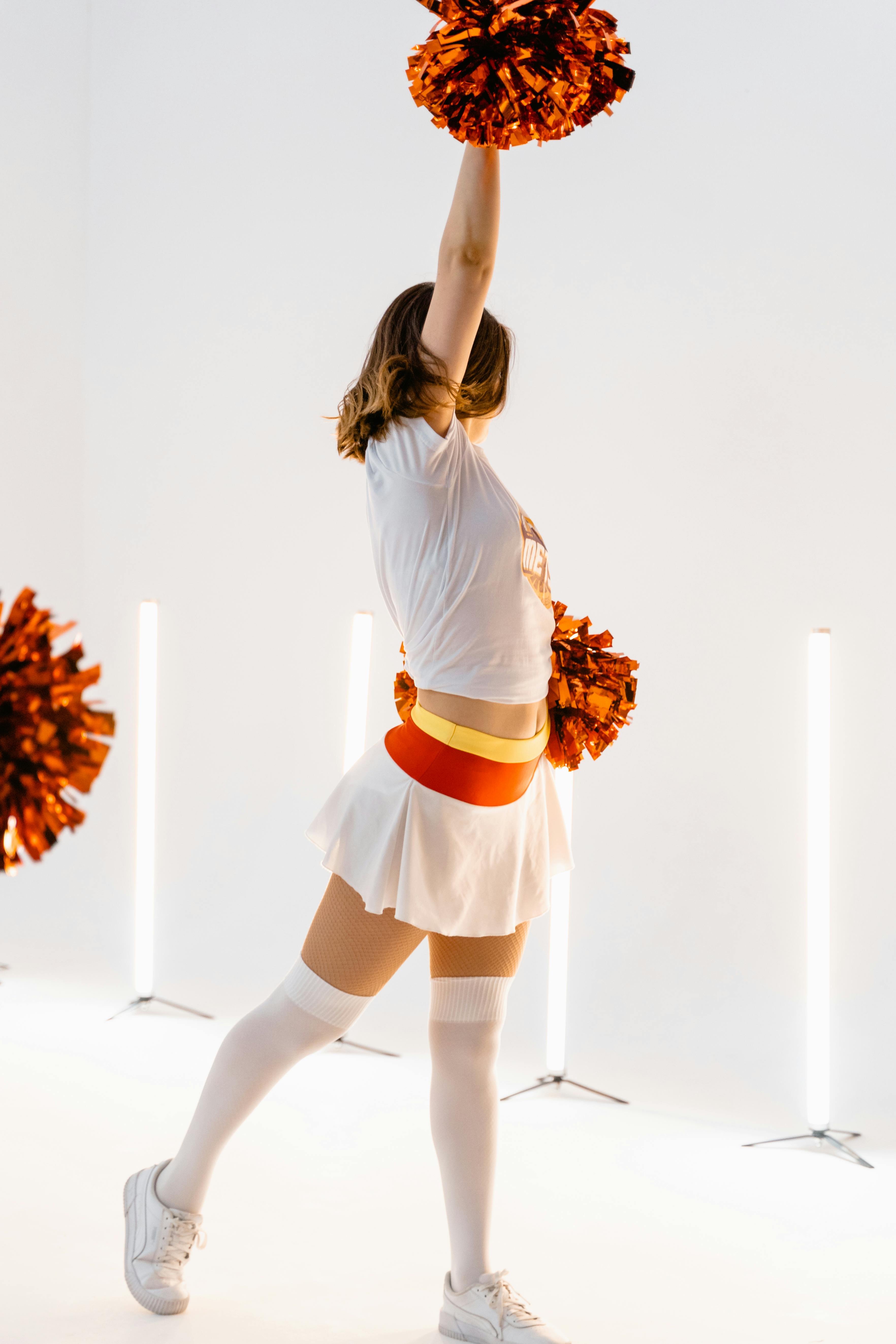 Portrait Of A Cheerleader Dancing With Pompoms High-Res Stock Photo - Getty  Images