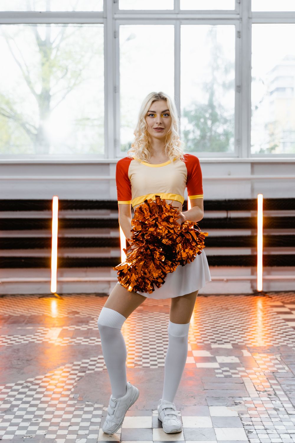 Cheerleader holding pom-poms