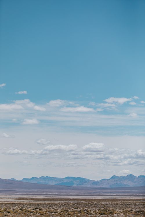A Mountains Under the White Clouds and Blue Sky · Free Stock Photo