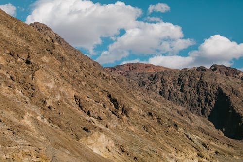 White Clouds and Blue Sky Over a Rocky Mountain