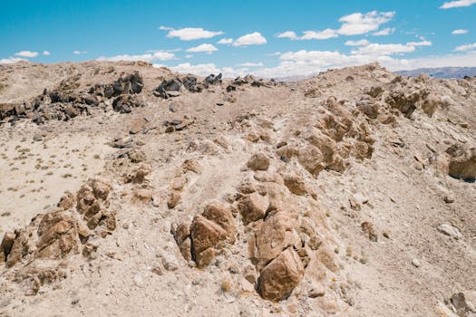 A scenic view of a barren rocky mountain landscape under a cloudy sky, showcasing natural beauty.