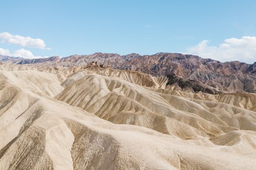 Free Beautiful eroded desert landscape of Death Valley National Park under a clear blue sky. Stock Photo