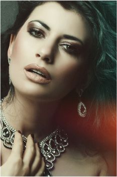Stunning close-up portrait of an elegant woman wearing exquisite jewelry, showcasing beauty and glamour.
