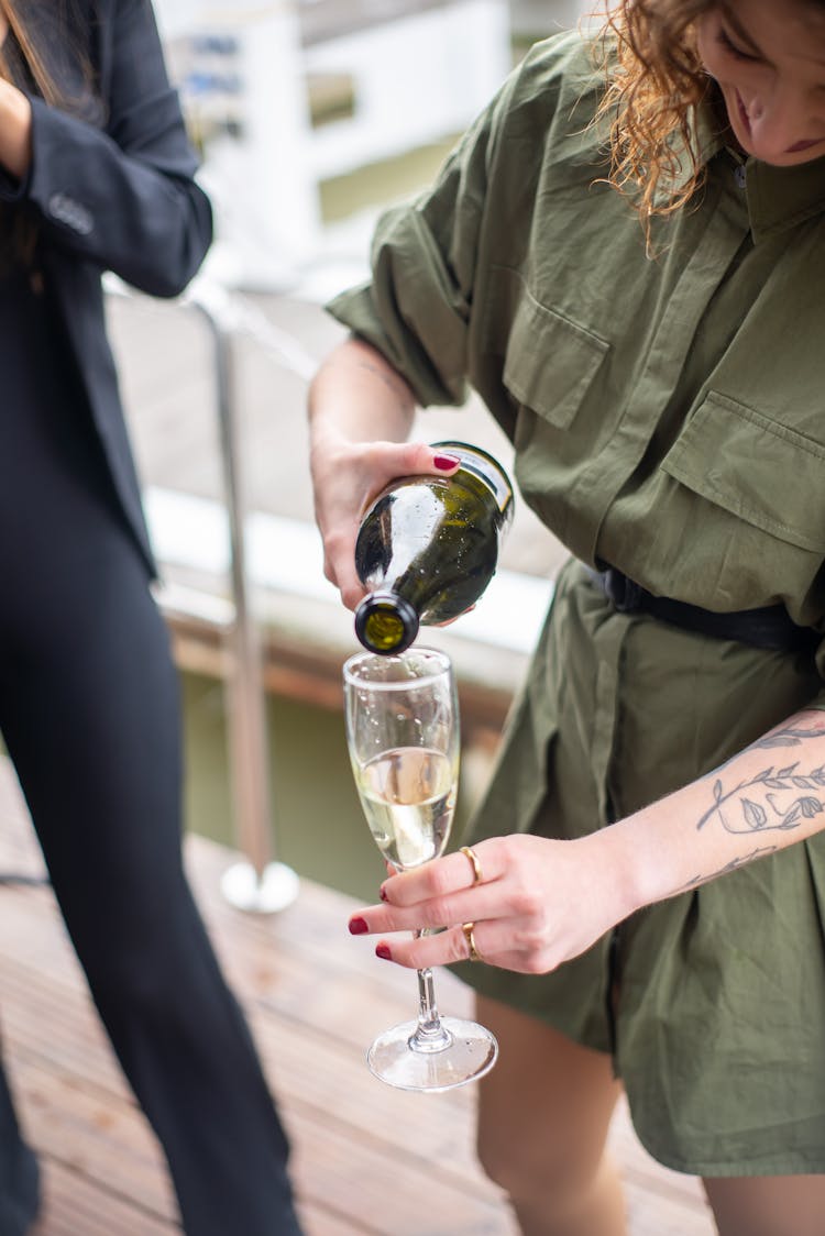 A Woman Pouring Wine In A Glass