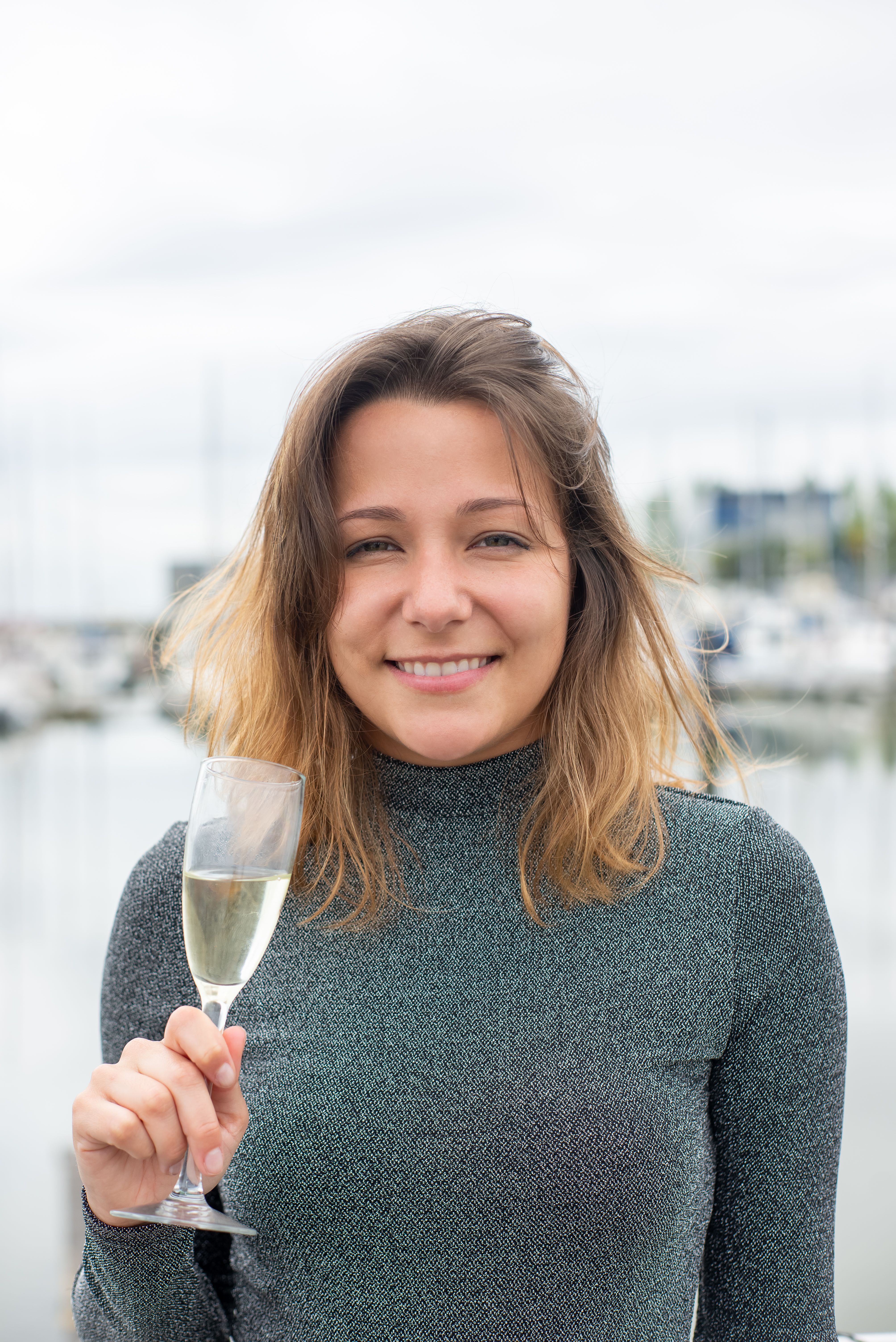 Woman in Gray Long Sleeves Holding a Glass of Wine · Free Stock Photo